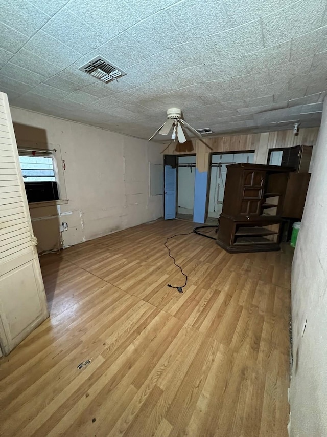 107 Thompson St, El Campo, TX 77437 - unfurnished living room featuring a ceiling fan and wood finished floors