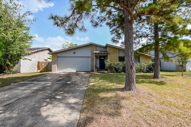 ranch-style home with a garage and a front yard