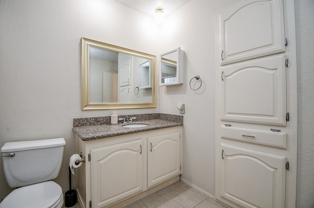 bathroom with vanity, tile patterned floors, and toilet