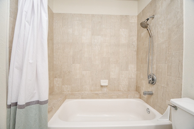 bathroom with toilet and shower / bath combo with shower curtain