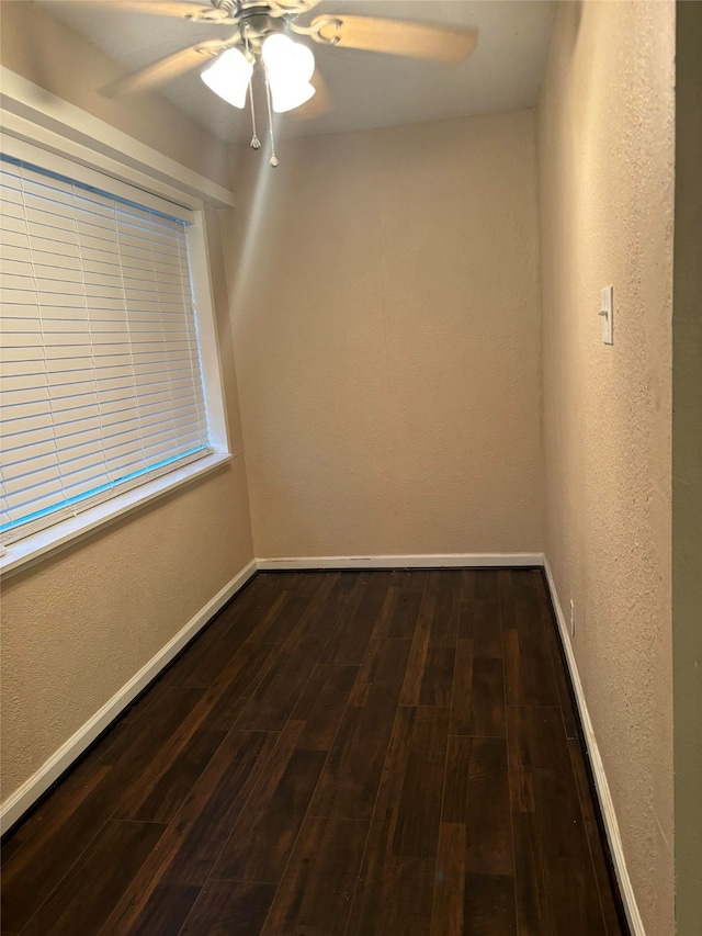 spare room with ceiling fan and dark hardwood / wood-style flooring