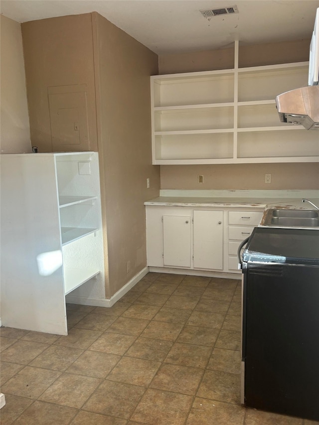 kitchen featuring white cabinetry, sink, and black electric range oven