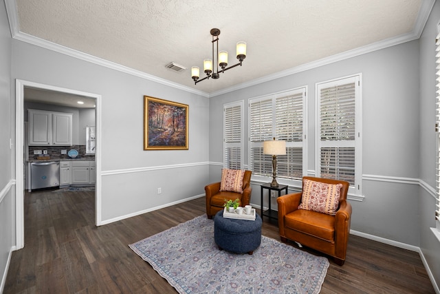 living area with dark wood-type flooring, a textured ceiling, an inviting chandelier, and ornamental molding