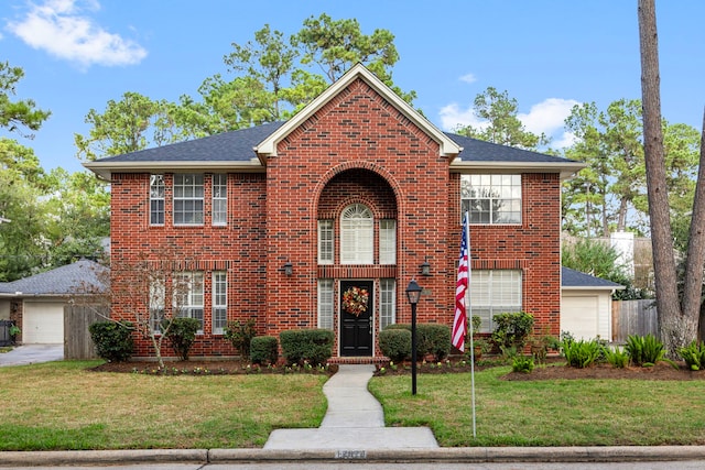 view of front of property with a garage and a front lawn