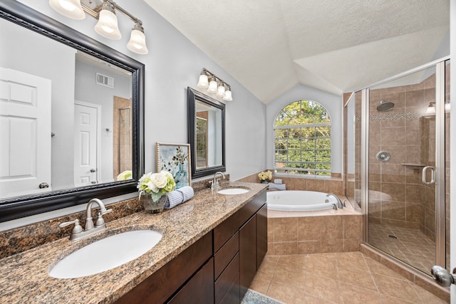 bathroom featuring plus walk in shower, lofted ceiling, a textured ceiling, and tile patterned flooring