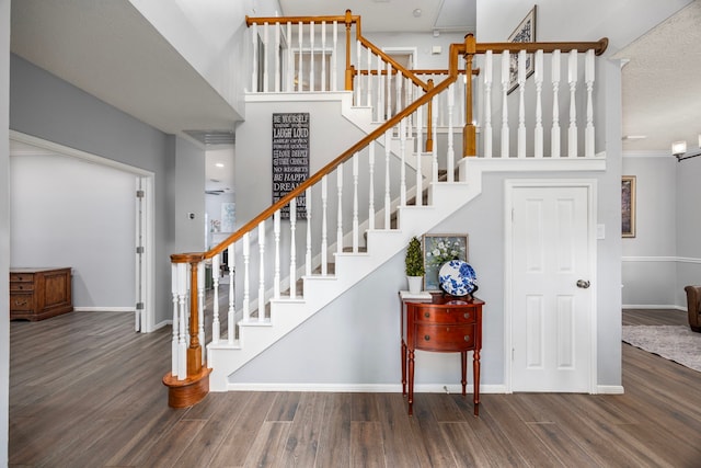 staircase with hardwood / wood-style floors