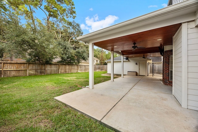 view of yard featuring a patio area and ceiling fan