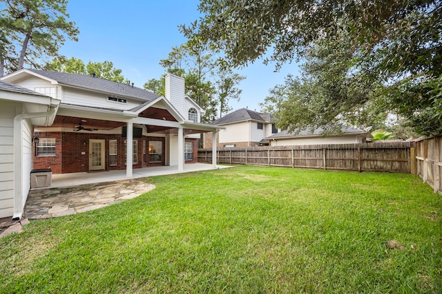 view of yard with ceiling fan and a patio area