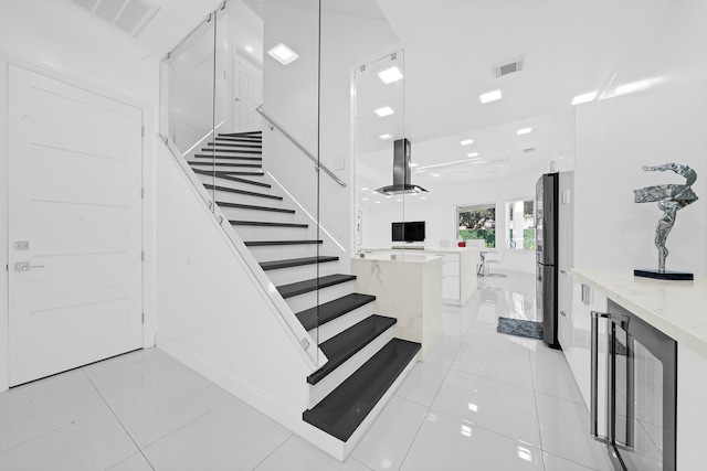 stairs featuring tile patterned floors and wine cooler