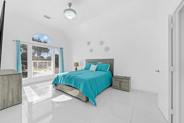 bedroom featuring light tile patterned floors and vaulted ceiling