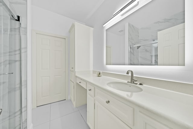 bathroom featuring vanity, tile patterned flooring, and a shower with shower door