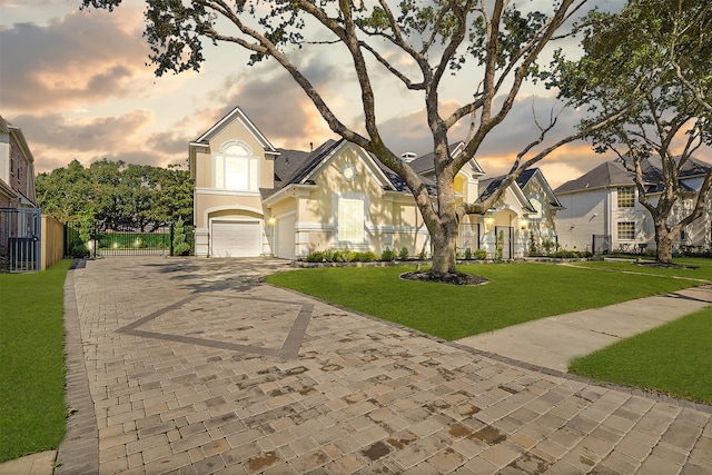 view of front of house with a lawn and a garage