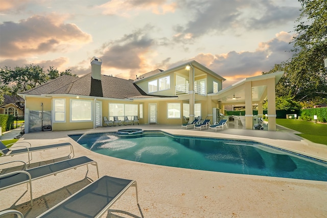 pool at dusk featuring a patio