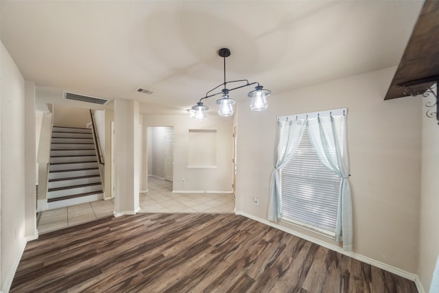 unfurnished dining area featuring hardwood / wood-style flooring