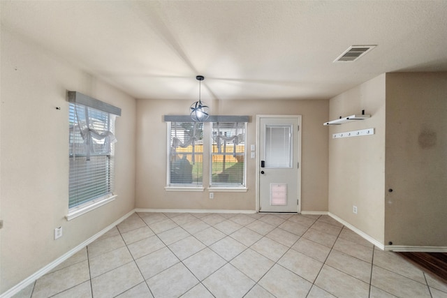 unfurnished dining area with light tile patterned floors