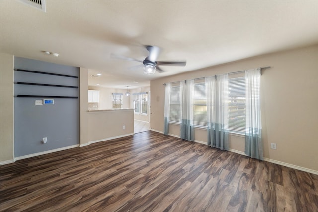 unfurnished living room with dark wood-type flooring and ceiling fan