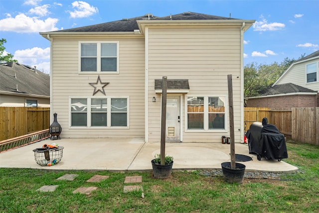 back of property featuring a patio and a yard