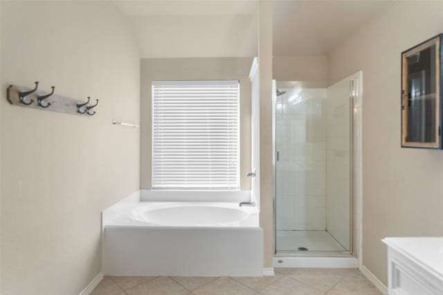 bathroom with independent shower and bath and tile patterned flooring