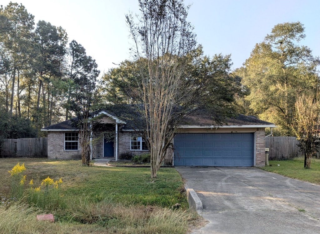 ranch-style house with a garage and a front yard