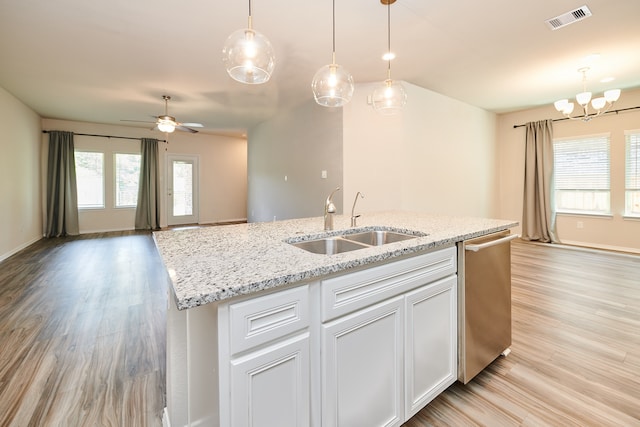 kitchen with light hardwood / wood-style floors, dishwasher, hanging light fixtures, sink, and white cabinetry