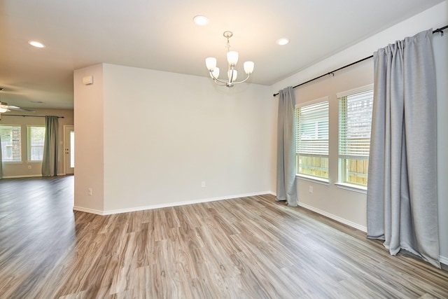 9291 Inland Leather Ln, Conroe, TX 77385 - unfurnished room with a chandelier, light wood-style flooring, recessed lighting, ceiling fan, and baseboards