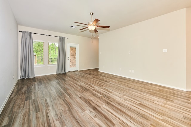 spare room featuring light hardwood / wood-style floors and ceiling fan