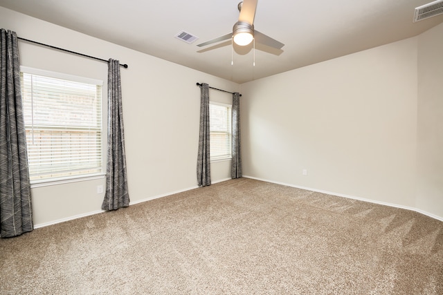 unfurnished room featuring ceiling fan and carpet floors