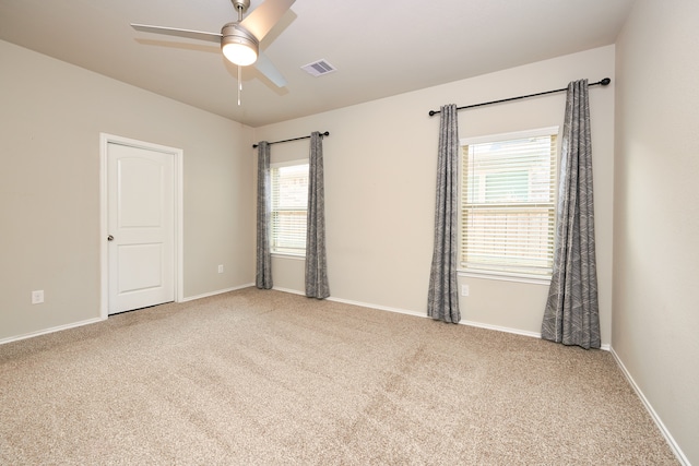 carpeted empty room featuring ceiling fan