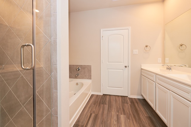 bathroom with vanity, hardwood / wood-style flooring, and independent shower and bath