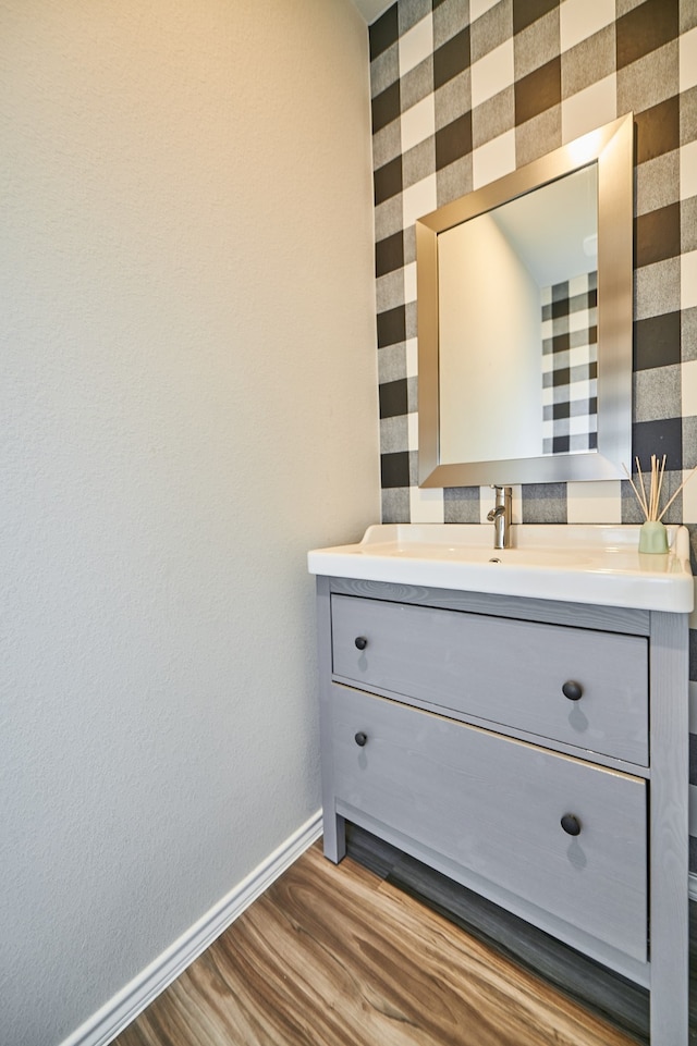 bathroom with hardwood / wood-style flooring and vanity