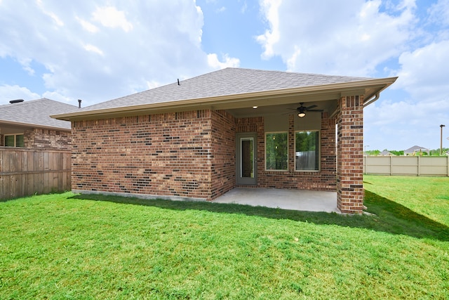 rear view of house featuring a lawn, ceiling fan, and a patio area