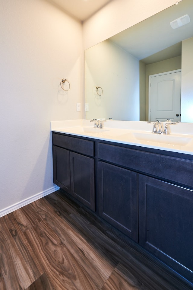 bathroom with hardwood / wood-style floors and vanity