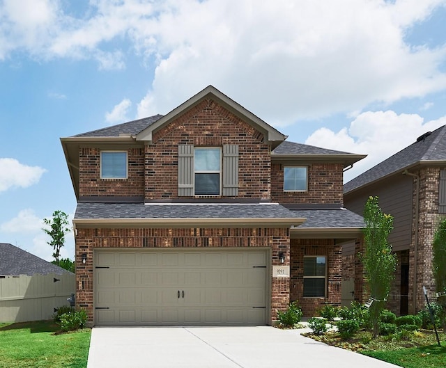 9291 Inland Leather Ln, Conroe, TX 77385 - view of front of home with brick siding, driveway, a garage, and roof with shingles