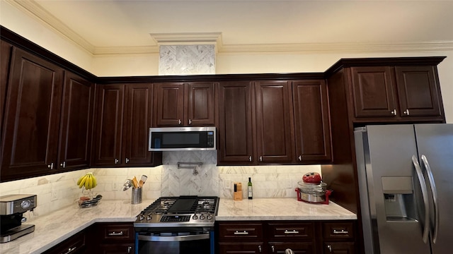 kitchen with dark brown cabinetry, crown molding, light stone counters, stainless steel appliances, and decorative backsplash