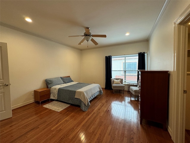 bedroom featuring crown molding, dark wood-type flooring, and ceiling fan