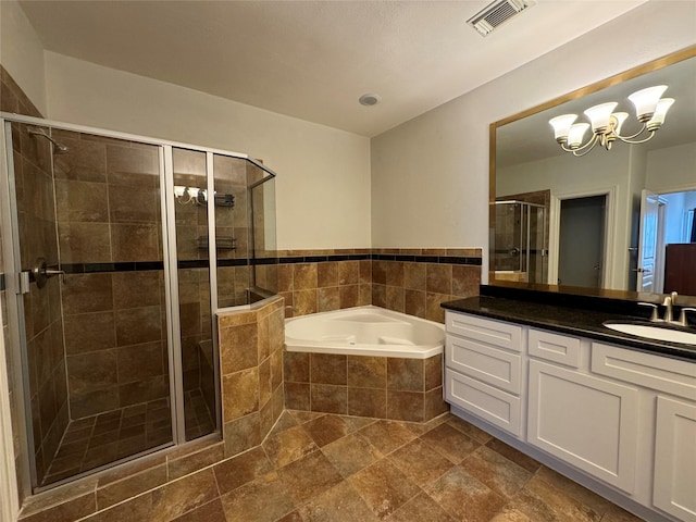 bathroom featuring vanity, independent shower and bath, and a notable chandelier