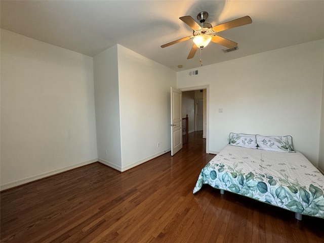 unfurnished bedroom with dark hardwood / wood-style floors and ceiling fan