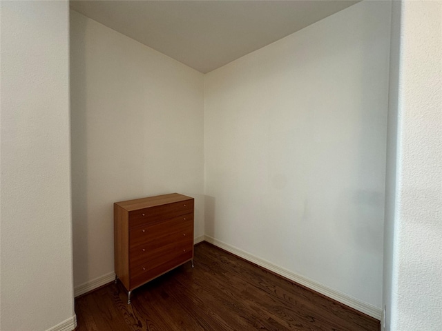 unfurnished room with dark hardwood / wood-style floors