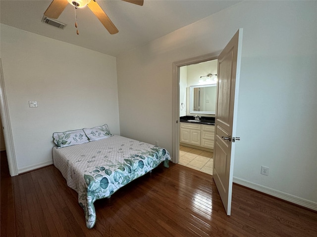 bedroom with ceiling fan, ensuite bath, sink, and light hardwood / wood-style flooring