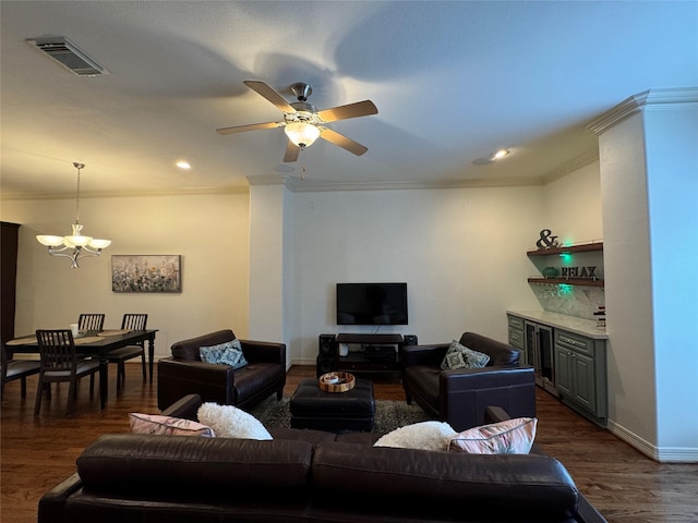 living room with crown molding, dark wood-type flooring, and ceiling fan with notable chandelier