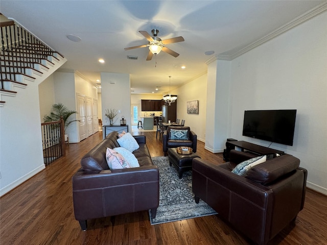 living room with crown molding, ceiling fan with notable chandelier, and hardwood / wood-style floors