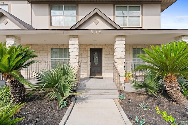 view of exterior entry featuring a porch