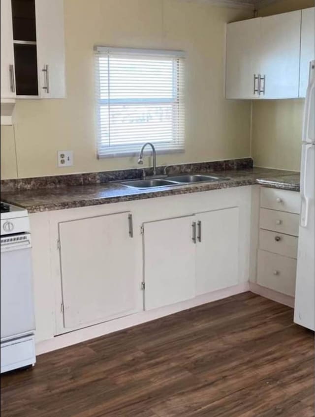 kitchen featuring white cabinets, sink, white appliances, and dark hardwood / wood-style floors