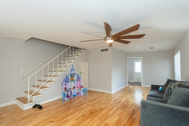 living room with hardwood / wood-style floors and ceiling fan