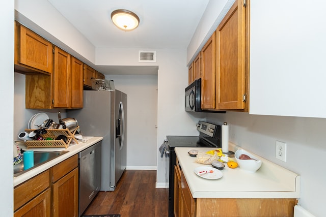 kitchen featuring stainless steel dishwasher, range with electric stovetop, and dark wood-type flooring