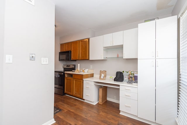 kitchen with white cabinets, built in desk, dark hardwood / wood-style floors, and stainless steel electric range oven