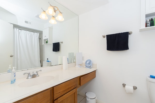 bathroom featuring vanity and toilet