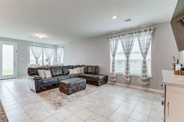 living room featuring light tile patterned floors and a textured ceiling