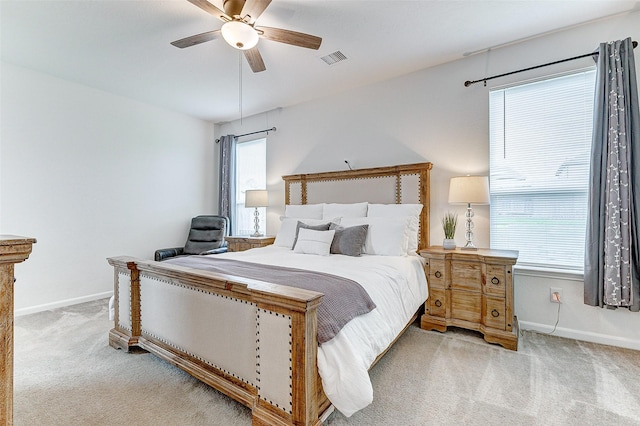 bedroom with ceiling fan and light carpet