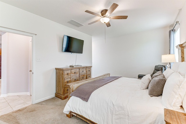 bedroom with ceiling fan and light colored carpet